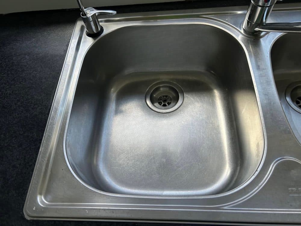 The same kitchen sink after cleaning, shining